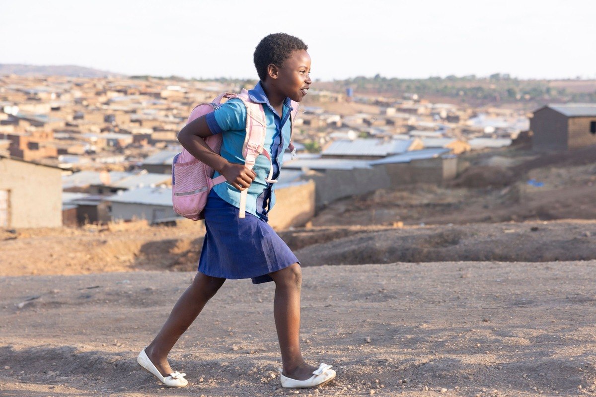 Schoolgirl walking with a backpack
