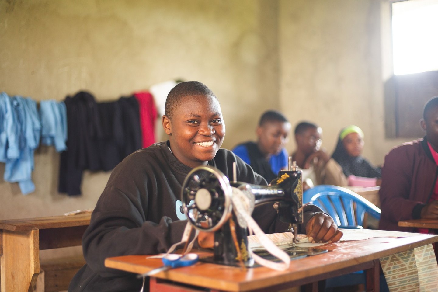 Young woman working at a sewing machine