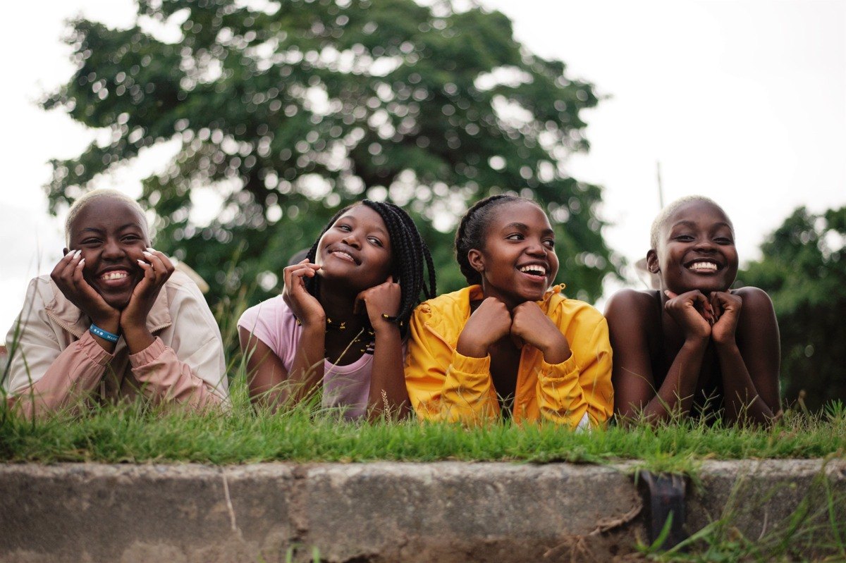 Four girls smiling together outdoors
